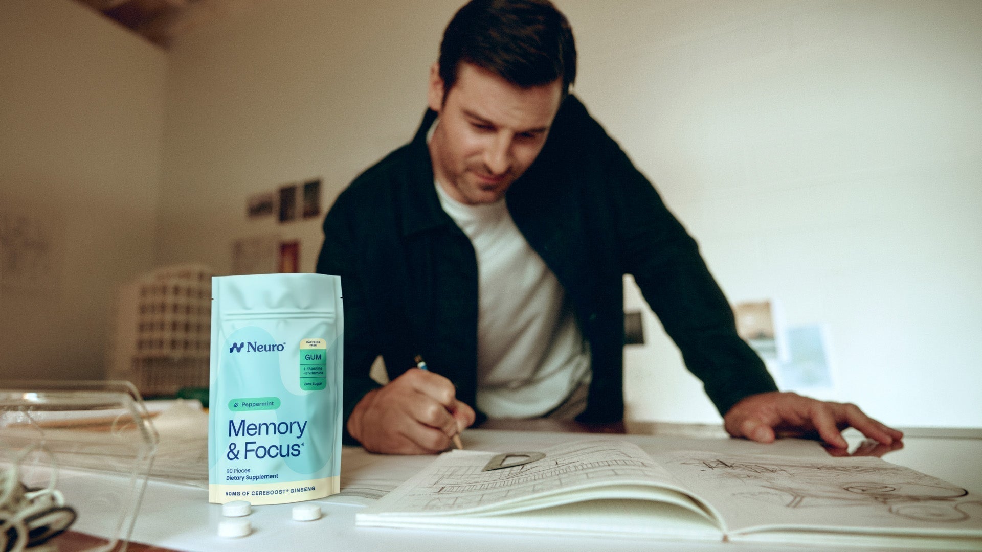 man in his 40s studying with a package of Memory & Focus gum on the desk