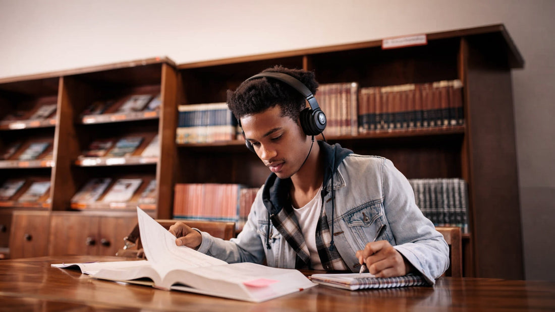 A focused student studying for exams at the library