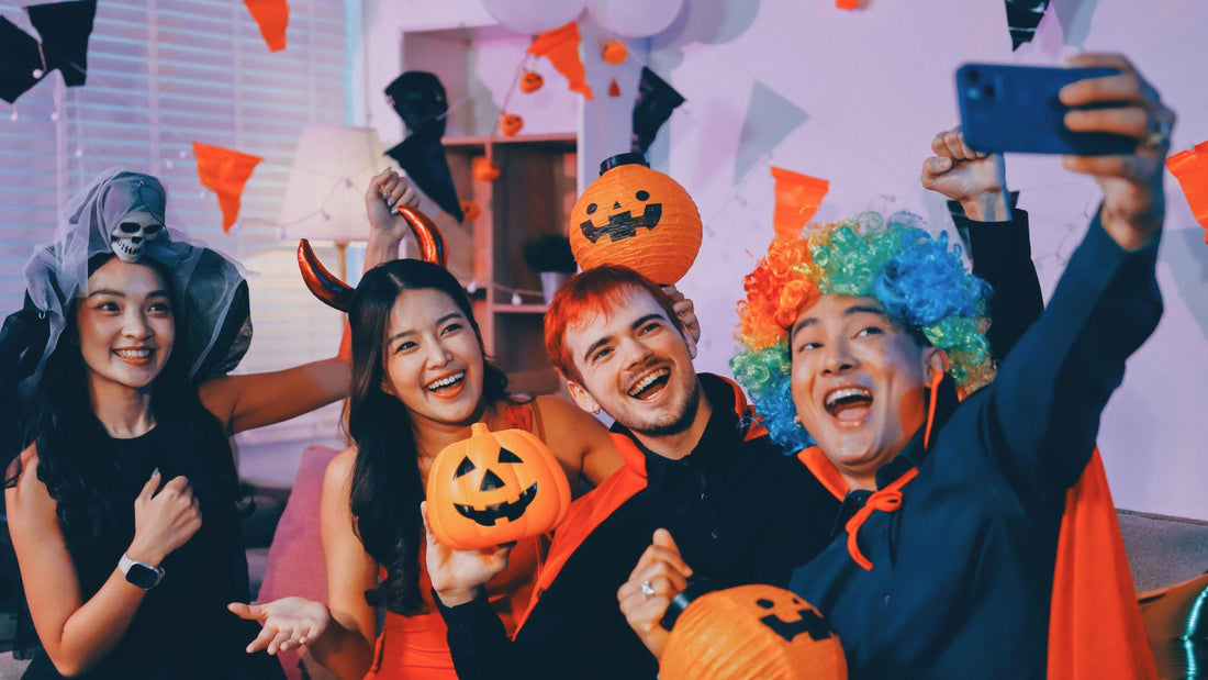 A Halloween party with a group of people in costumes taking a selfie and having fun