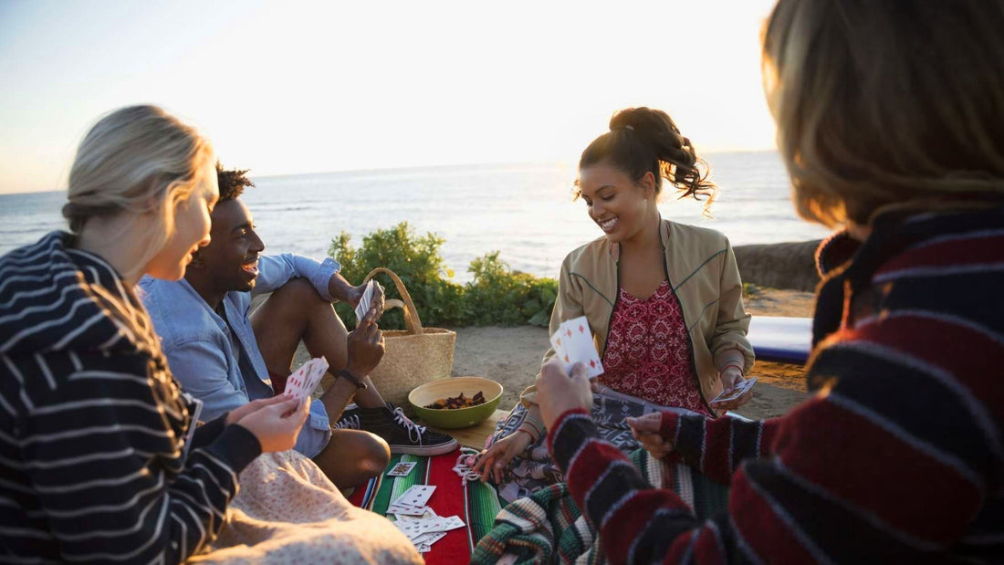 friends playing card games at the beach