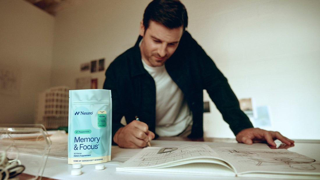 man in his 40s studying with a package of Memory & Focus gum on the desk